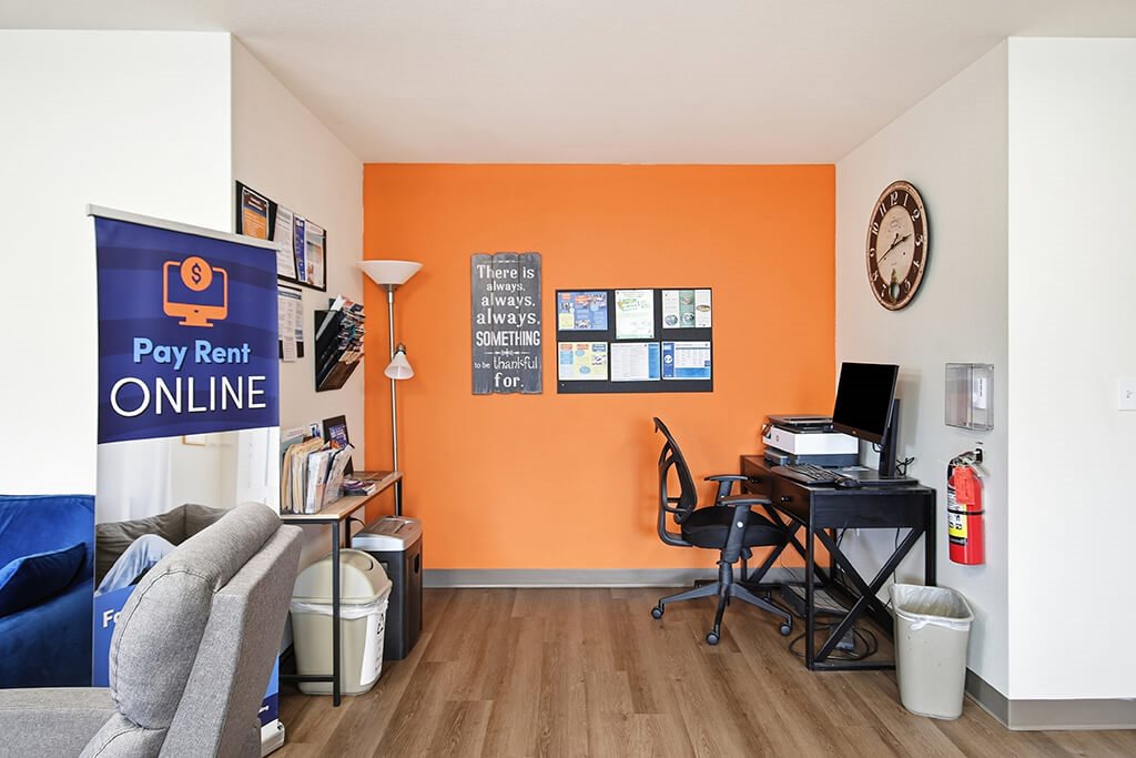 A room with orange walls has a sign that says there is always a way.